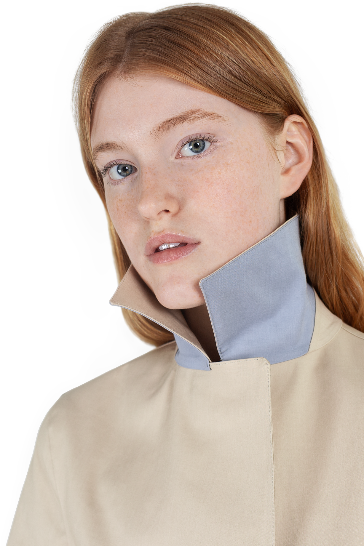 Close up shot of female ginger model wearing sandstone Faeroes mackintosh with collar up showing iris contrast colour underside